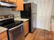 Kitchen featuring stainless steel appliances, granite countertops, and wooden cabinetry at 11121 S Harrowfield Rd, Charlotte, NC 28226