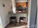 Eat-in kitchen with granite countertops, breakfast bar and wooden cabinets at 11121 S Harrowfield Rd, Charlotte, NC 28226