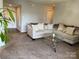 Comfortable living room featuring plush seating, neutral decor, and ample space at 11121 S Harrowfield Rd, Charlotte, NC 28226