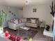 Well-lit living room featuring neutral colors, a decorative fireplace, and plush seating at 11121 S Harrowfield Rd, Charlotte, NC 28226