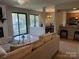 Open-concept living area with fireplace, sliding glass doors to balcony and combined kitchen and dining room at 11121 S Harrowfield Rd, Charlotte, NC 28226