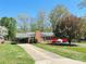 Charming brick home with a well-manicured lawn and colorful landscaping, including a flowering tree and azaleas at 1160 Nw 11Th Street Cir, Hickory, NC 28601