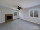Bedroom with fireplace, carpet flooring, and wooded views at 122 Cricket Creek Dr, Cherryville, NC 28021