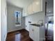 Laundry room with sink, cabinets and wood floors at 122 Cricket Creek Dr, Cherryville, NC 28021