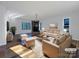 Virtually staged living room with fireplace and hardwood floors at 122 Cricket Creek Dr, Cherryville, NC 28021