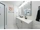 Stylish bathroom with double sinks, modern fixtures, and a walk-in shower at 1233 Rollingwood Dr, Charlotte, NC 28217