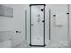 Updated bathroom with a glass enclosed shower and white tile at 1233 Rollingwood Dr, Charlotte, NC 28217