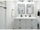 Clean bathroom with updated vanity, dual sinks, and large mirrors at 1233 Rollingwood Dr, Charlotte, NC 28217