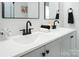 Modern bathroom with dual sinks, black matte fixtures, and a large mirror at 1233 Rollingwood Dr, Charlotte, NC 28217