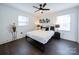 Bedroom with a queen bed, dark wood floors and ceiling fan at 1233 Rollingwood Dr, Charlotte, NC 28217