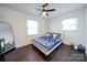 Bedroom with a full bed, dark wood floors and ceiling fan at 1233 Rollingwood Dr, Charlotte, NC 28217