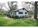 Charming ranch home with white brick exterior and black trim at 1233 Rollingwood Dr, Charlotte, NC 28217