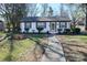 Charming single-story home with a tidy front yard and a walkway leading to the front door at 1233 Rollingwood Dr, Charlotte, NC 28217