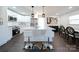 Modern kitchen with white cabinets, island, and stainless steel appliances at 1233 Rollingwood Dr, Charlotte, NC 28217