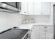 Modern kitchen with white cabinets and quartz countertops at 1233 Rollingwood Dr, Charlotte, NC 28217