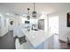 Modern kitchen with white cabinets, island, and breakfast bar at 1233 Rollingwood Dr, Charlotte, NC 28217