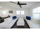 Bright living room with white couches, blue pillows, and hardwood floors at 1233 Rollingwood Dr, Charlotte, NC 28217