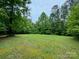 Open grassy area with lush green lawn and mature trees at 176 Butch Branch Rd, Union Grove, NC 28689