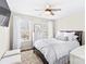 Bright bedroom with a queen-size bed, large windows, and a ceiling fan at 19510 Deer Valley Dr, Cornelius, NC 28031
