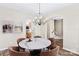 Bright dining room with round table and chandelier, open to kitchen at 19510 Deer Valley Dr, Cornelius, NC 28031