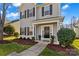 Two-story house with gray siding, black shutters, and a front porch at 19510 Deer Valley Dr, Cornelius, NC 28031