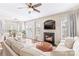 Living room with fireplace, large sectional sofa, and hardwood floors at 19510 Deer Valley Dr, Cornelius, NC 28031