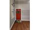Inviting entryway with red door, wreath, and wood floors at 201 Hoskins Rd # 115, Charlotte, NC 28208