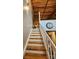 Wooden staircase with white railing leading to upper level at 201 Hoskins Rd # 115, Charlotte, NC 28208