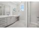 Bathroom with double sink vanity, granite countertops, and natural light at 224 Windy Dell Dr, Tega Cay, SC 29708