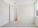 Bright bedroom with neutral walls, trim, plush carpet and a window letting in natural light at 224 Windy Dell Dr, Tega Cay, SC 29708