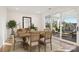 Elegant dining room featuring hardwood floors, a wood table, and sliding glass doors leading to an outdoor patio at 224 Windy Dell Dr, Tega Cay, SC 29708