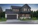 Two-story farmhouse with gray siding, stone accents, and a two-car garage at 224 Windy Dell Dr, Tega Cay, SC 29708