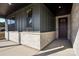 Inviting front porch featuring stone accents, a dark gray facade, and a stylish entryway door at 224 Windy Dell Dr, Tega Cay, SC 29708