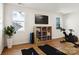 Home gym featuring two yoga mats, storage shelves, a wall-mounted TV, and natural light from two windows at 224 Windy Dell Dr, Tega Cay, SC 29708