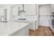 Bright kitchen featuring a large island with stone countertops and white shaker cabinets at 224 Windy Dell Dr, Tega Cay, SC 29708