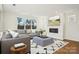 Comfortable living room with a grey couch, a modern fireplace, a geometric rug, and a bright window view at 224 Windy Dell Dr, Tega Cay, SC 29708