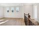 Open upstairs loft with hardwood floors, recessed lighting, and three large windows for ample natural light at 224 Windy Dell Dr, Tega Cay, SC 29708