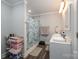 Bright bathroom with a double sink vanity, updated fixtures, and tiled shower and tub at 2752 Peachtree Rd, Statesville, NC 28625