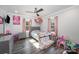 Cozy bedroom featuring hardwood floors, natural light, and comfortable furnishings at 2752 Peachtree Rd, Statesville, NC 28625
