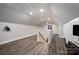 Spacious upstairs bonus room with wood floors, a ceiling fan, and a staircase with a safety gate at 2752 Peachtree Rd, Statesville, NC 28625