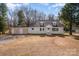 Charming single-story home featuring a detached two-car garage with a basketball hoop and mature trees at 2752 Peachtree Rd, Statesville, NC 28625