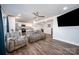 Open-concept living room boasts wood floors, modern furniture, and seamless transition to the modern kitchen at 2752 Peachtree Rd, Statesville, NC 28625