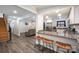 Open concept living space features wood flooring, a breakfast bar, and a comfortable lounging area at 2752 Peachtree Rd, Statesville, NC 28625