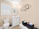 Bathroom featuring a toilet, sink, window and a small amount of storage at 311 Kaitlyn Ln, Kings Mountain, NC 28086