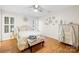Bright bedroom with hardwood floors, natural light, and a stylish upholstered bench at 311 Kaitlyn Ln, Kings Mountain, NC 28086