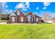 Well-maintained brick home with a lush green lawn and mature landscaping at 311 Kaitlyn Ln, Kings Mountain, NC 28086