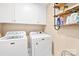Functional laundry room features updated washer and dryer, shelves, and storage at 311 Kaitlyn Ln, Kings Mountain, NC 28086