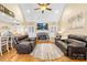 Inviting living room with a vaulted ceiling, cozy fireplace, and plush leather seating for ultimate relaxation at 311 Kaitlyn Ln, Kings Mountain, NC 28086