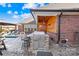 Outdoor kitchen with stainless steel grill, bar seating, and a wood paneled ceiling at 311 Kaitlyn Ln, Kings Mountain, NC 28086
