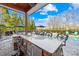 Large outdoor stone kitchen and bar area featuring sink, grill, storage and barstool seating, next to pool at 311 Kaitlyn Ln, Kings Mountain, NC 28086